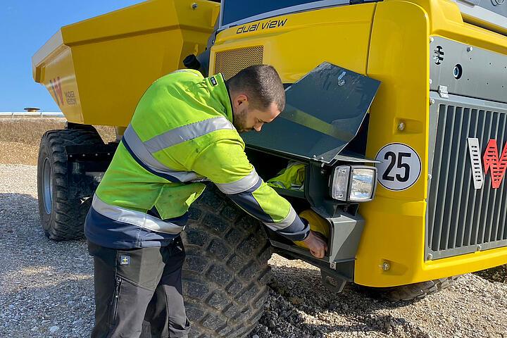 Mechanic carrying out repairs on construction plant machinery